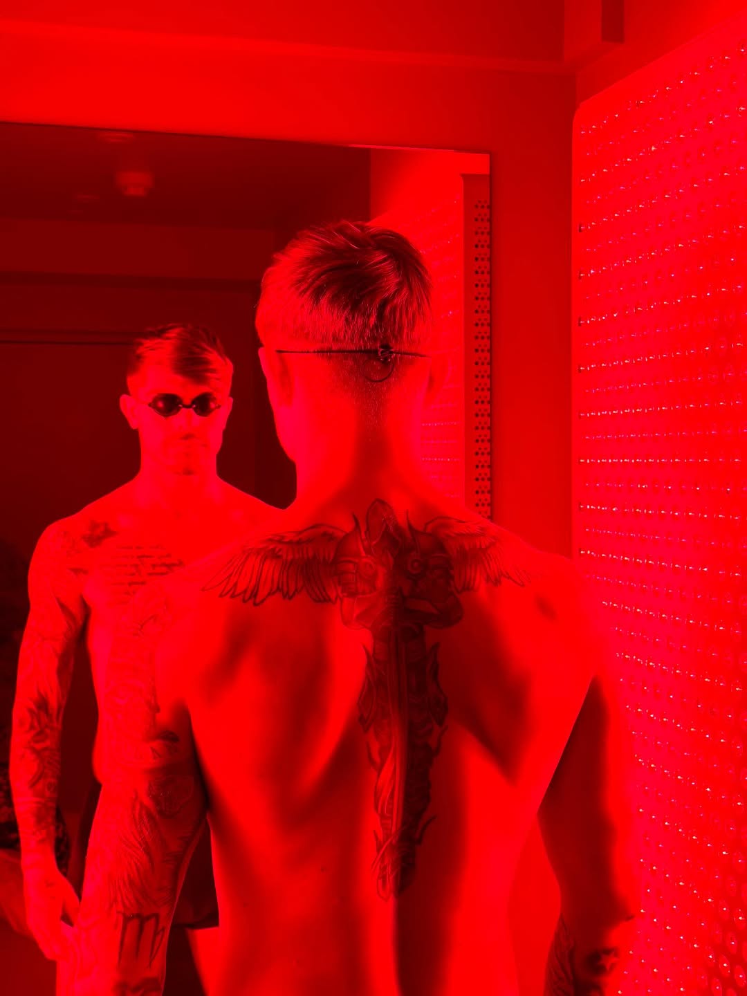 Client standing inside Brysk's full body red light therapy room in Manchester