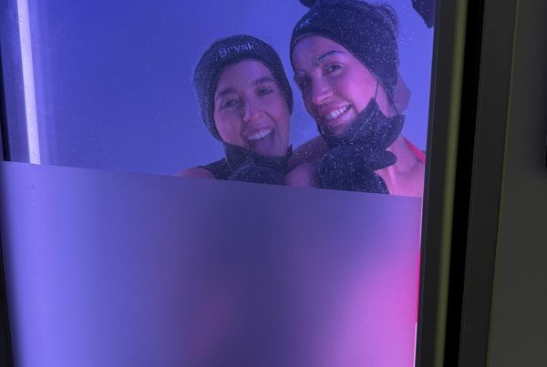 Two clients posing during a shared whole body cryotherapy session at Brysk in Manchester