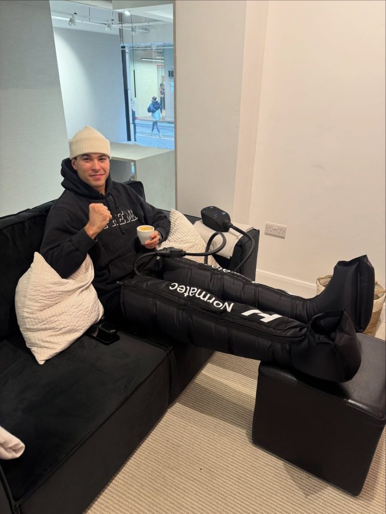 Client relaxing during a compression boot therapy session at Brysk in Manchester