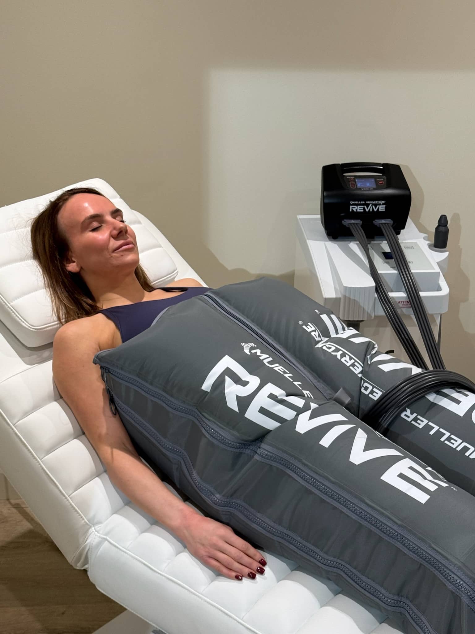 Woman using lymphatic drainage compression therapy at Brysk Manchester