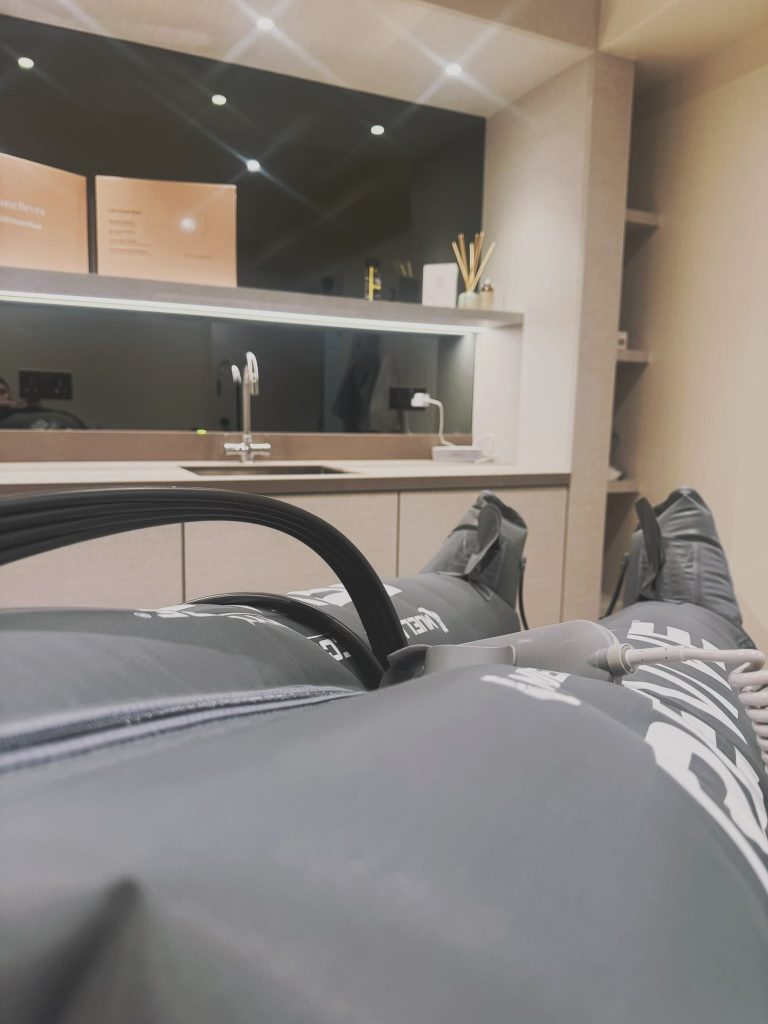 Client during lymphatic drainage compression session at Brysk